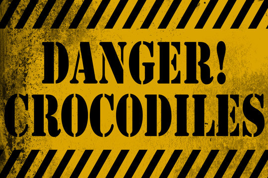 Danger crocodiles sign yellow with stripes