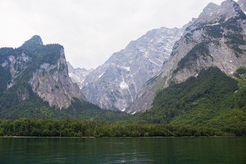 Fototapeta na wymiar Large stone mountains in the Alps on Konigssee Lake