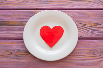 Love heart on a plate. The concept of nutrition love, heartwarming, losing weight because of love.