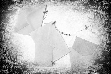 Post envelopes and vintage blank cards. Word love made of a plastic letters. All objects are hanging on a rope attached with clothes clothespins. Old paper textured image
