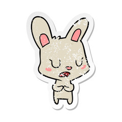 distressed sticker of a cartoon rabbit talking