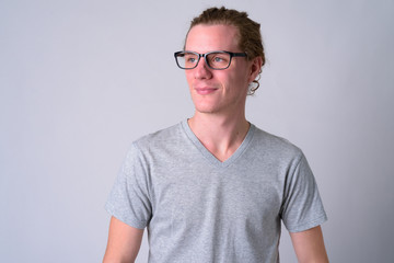 Fototapeta premium Face of young handsome man with eyeglasses thinking