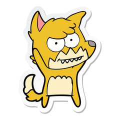 sticker of a cartoon grinning fox