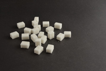 Sugar cubes on black background