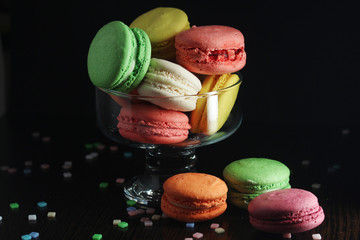 Bright macaroons against dark background