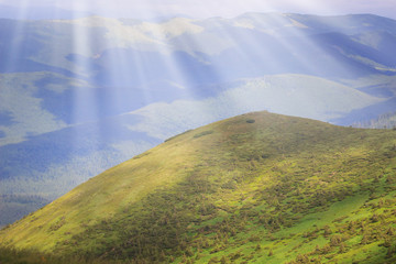 Green hills in mountain valley. Summer landscape