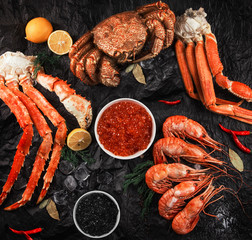 Set of seafood: red and black caviar, limb of hairy crab, limb of snow crab, far eastern kamchatka crab