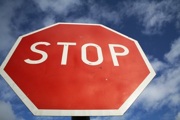 Stop sign against blue sky