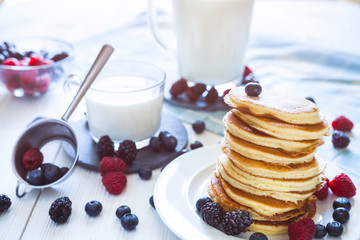 Delicious homemade pancakes with berries and milk