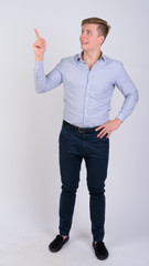 Full body shot of happy young blonde businessman thinking and pointing up