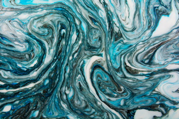 Abstract beautiful marbling with white and blue colors.The Eastern style of Ebru painting on water with acrylic paints swirls marbling.A stylish mix of natural luxury 