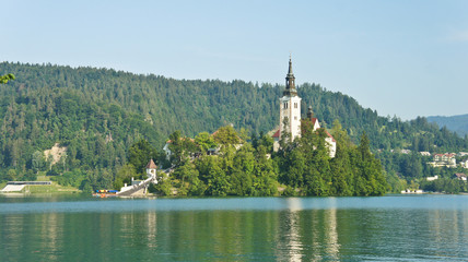Scenic view over Lake Bled, Julian Alps mountains and church on the island, sunny day, Bled, Slovenia