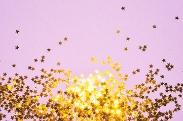 Golden glitter stars on purple background in vintage colors