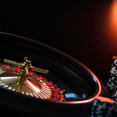  Casino background,  poker Chips on gaming table, roulette wheel in motion,