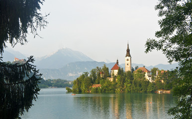 Fototapeta na wymiar Scenic view over Lake Bled, Julian Alps and church on the island, sunny morning, Bled, Slovenia