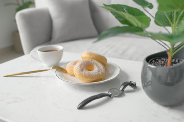 Classic donut. Morning breakfast on table in living room at home.