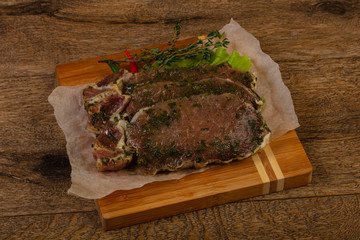 Raw marinated pork steak
