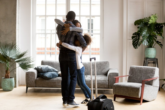 Happy African American Family Hug Welcoming Dad Home