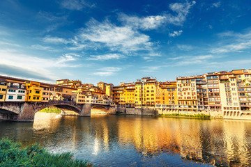 Scenic view on Ponte Vecchio in Florence, Italy, on a summer day. Colorful travel background.