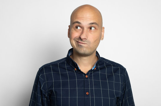 portrait of a bald guy smirking