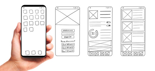 UI development. Male hand holding smartphone with wireframed user interface screen prototypes of a...