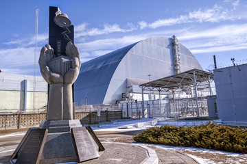 Monument, fourth reactor and its enclosing sarcophagus in Chernobyl Exclusion Zone, Ukraine
