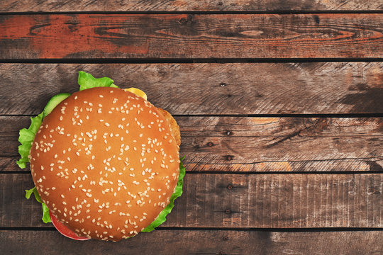 Burger On Old Wooden Background Above View