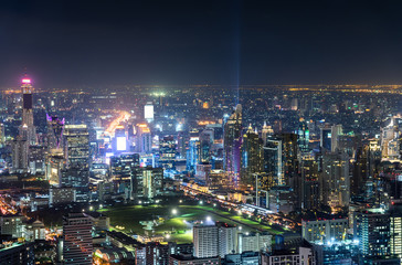 Fototapeta na wymiar Cityscape with buildings crowded illumination with traffic light in Bangkok
