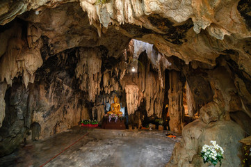 Stalactite limestone cave with buddha statue