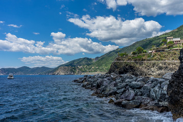 Fototapeta na wymiar Italy, Cinque Terre, Manarola, a large body of water with a mountain in the background