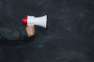 hand with megaphone and school