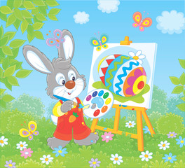 Little Bunny drawing a colorful Easter egg on its canvas on green grass among flowers on a sunny spring day, vector illustration in a cartoon style