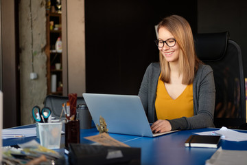 A girl works at a computer in a modern office