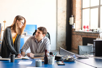 Man and woman work in a modern office. Project Discussion.