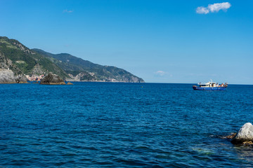 Italy, Cinque Terre, Monterosso, a large body of water with a mountain in the background