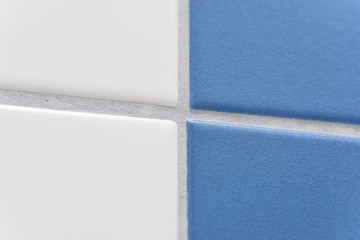 blue and white tiles with grey tile joints in a bathroom