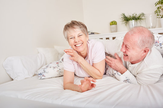 Senior couple having fun in bedroom