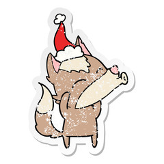 howling wolf distressed sticker cartoon of a wearing santa hat