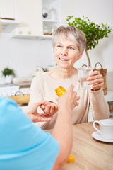 Woman gives senior medication