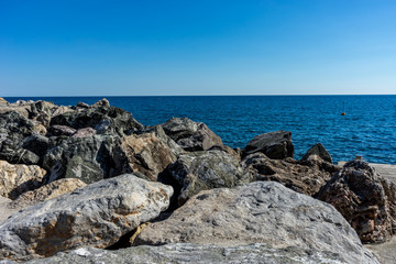 Italy, Cinque Terre, Monterosso, a rocky beach next to the ocean