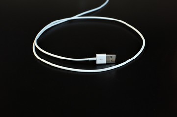 White data cable connector with USB isolated on black background with copy space
