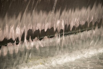 Abstract and close up of transparent falling water vertical flows.