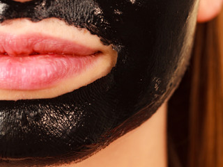 Girl black carbo peel off mask on face