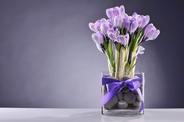 Spring flowers in glass vessels on a table