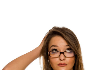 Obraz premium Half portrait of a young worried woman with glasses on white background