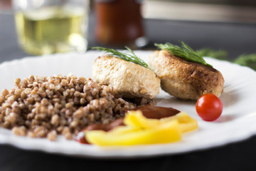 Chicken cutlets with buckwheat, herbs, ketchup and tomatoes