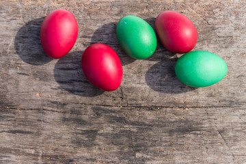 Painted Easter eggs on rustic wooden background