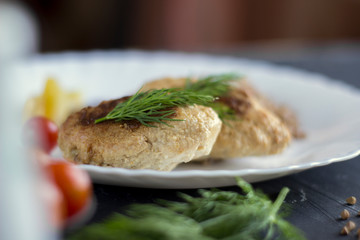 Chicken cutlets with buckwheat, herbs, ketchup and tomatoes
