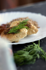 Chicken cutlets with buckwheat, herbs, ketchup and tomatoes