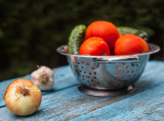 Tomatoes and cucumbers in the colander